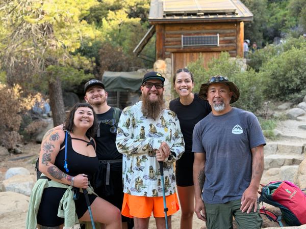 A group of hikers gathered outside