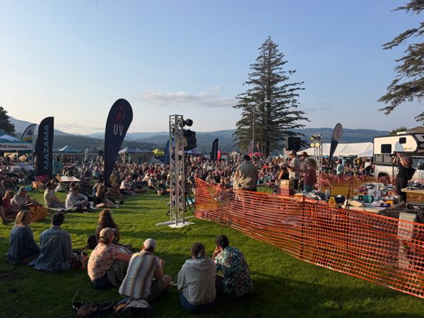 An outdoor hiker event with tents and a crowd